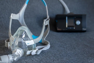 CPAP mask against a dark background