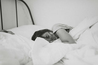 Black and white photo of a woman sleeping on her side